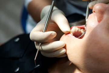 dentist a young white woman examines a patient a girl in a dental chair