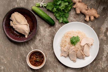 Asian healthy food chicken rice steam on brown background.