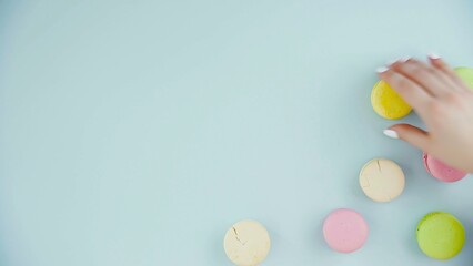 Top view of colorful french macarons on pastel blue background