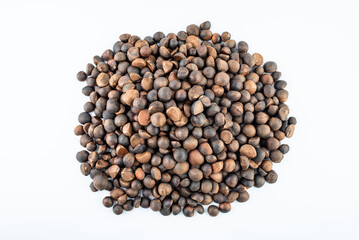 A pile of camellia seeds on a white background