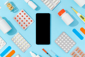 Different medicine pills and smartphone. Buying online drug delivery concept