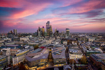 Colorful sunset with pink clouds over the urban skyline of the financial district City of London, England