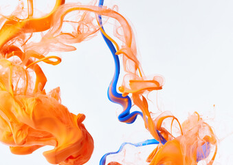 Paints splash curves in water on white. Acrylic orange and blue paint drop background. Abstract...