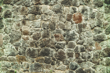 Abstract traditional stone wall pavement texture background. Bumpy textured stonewall made from flagstone and slabstone.