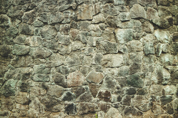 Abstract traditional stone wall pavement texture background. Bumpy textured stonewall made from flagstone and slabstone.