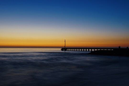 pier after the sunset with sky and sea