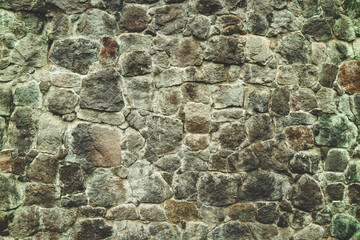 Abstract traditional stone wall pavement texture background. Bumpy textured stonewall made from flagstone and slabstone.
