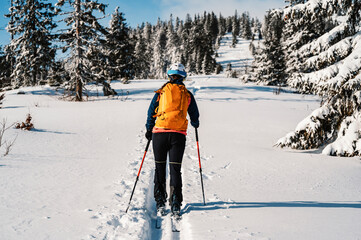 Mountaineer backcountry ski walking ski woman alpinist in the mountains. Ski touring in alpine...