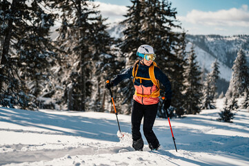 Mountaineer backcountry ski walking ski woman alpinist in the mountains. Ski touring in alpine...