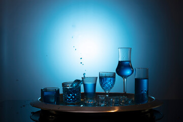 Alcoholic drinks on a blue background in a club. Tequila. Vodka. Cocktail