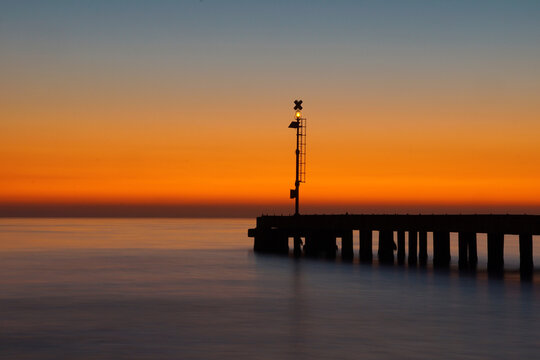 pier after the sunset with sky and sea