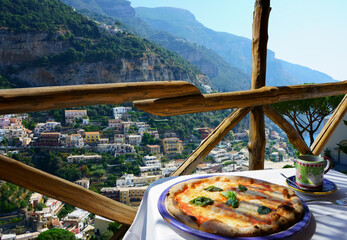    Pizza place terrace overlooking to beautiful Positano, Italy