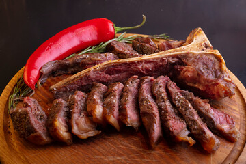 cooked sliced ​​ribeye steak on a wooden board