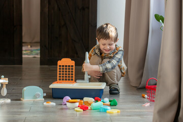 Little boy play with a toys at home