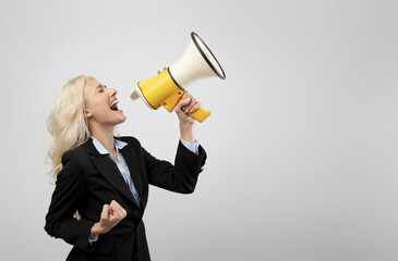Emotional businesswoman screaming with loudspeaker, making advertisement or announcement about sale...