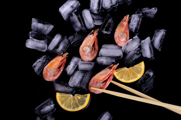shrimp on black background with ice cubes