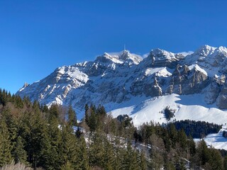 Winter ambience and beautiful idyllic atmosphere on the snow-capped Alpine mountain Alpstein in the Appenzell Alps massif - Switzerland (Schweiz)
