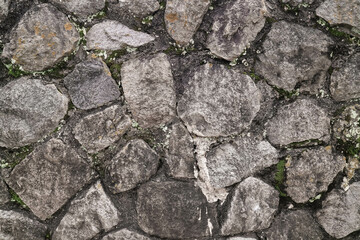 Abstract traditional stone wall pavement texture background. Bumpy textured stonewall made from flagstone and slabstone.