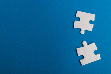 Jigsaw puzzle pieces on blue background.