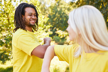 Young man and young woman while elbows greeting