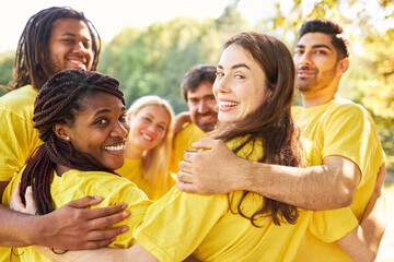 Multicultural people in the start-up team hug each other