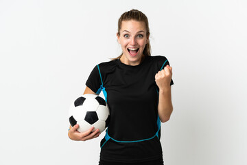 Young football player woman isolated on white background celebrating a victory in winner position