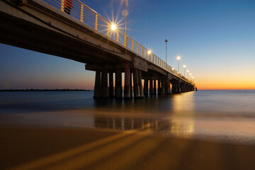 bridge after the sunset on the sea