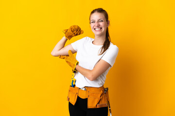 Young electrician woman isolated on yellow background doing strong gesture