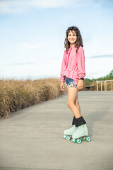 portrait of young child or teen girl roller skating outdoors, fitness, wellbeing, active healthy lifestyle, video clip