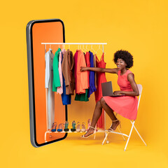African Woman Near Big Cellphone Shopping Online On Yellow Background