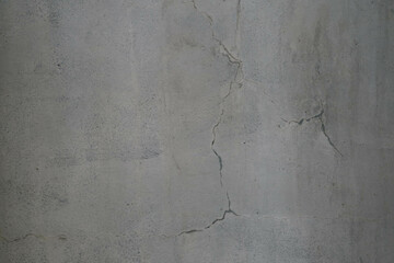 Old grunge dirty textured cement wall surface. With uneven stains and tiny holes.
