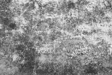 Old grunge dirty textured cement wall surface. With uneven stains and tiny holes.
