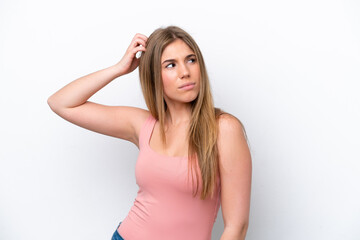 Fototapeta premium Young caucasian woman isolated on white bakcground having doubts while scratching head