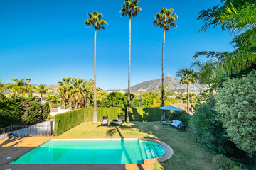 a image of the blue waters of private swimming pool inside a villa in Marbella  