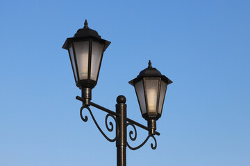 Fototapeta na wymiar Beautiful lighting lamppost on a blue sky background.