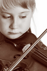 Beautiful little girl playing on violin. Isolated on the white background.