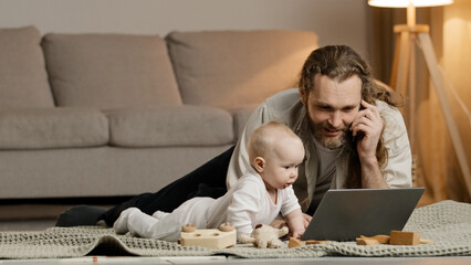 Single father adult stressed business man multitasking dad lying on floor at home with little...