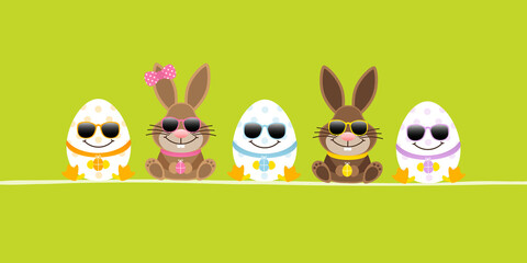 Obraz premium Sitzende Osterhasen Junge & Mädchen Mit 3 Ostereiern Sonnenbrille Banner Grün