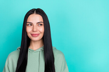 Photo of funny young black hairstyle lady look ad wear green hoodie isolated on teal color background