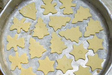 Raw shortbread cookies on a baking sheet. Making homemade cookies.