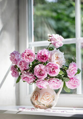 french garden pink roses in a vase on the window, summer day, cozy home, fragrances