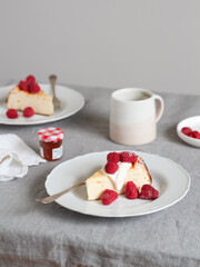Weekend breakfast table served with ricotta cake and frozen raspberries 