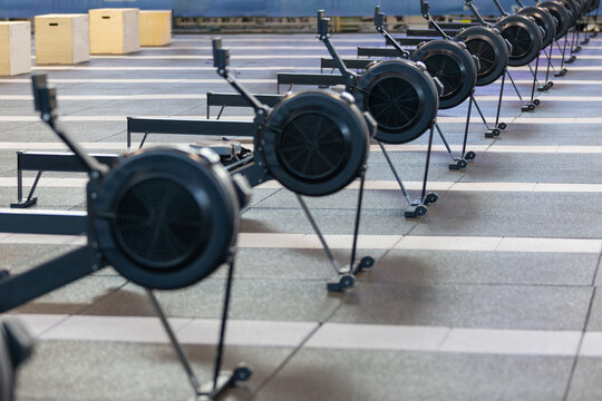 Group of Modern Black Rowing Machine at Gym: Fitness Equipment
