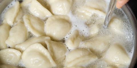 Meat Dumplings in boiling water. Meat dumplings are boiled in a pot of boiling water. Home fast food