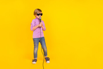 Full size photo of cheerful funny little guy future famous singer hold mic singing song isolated on...