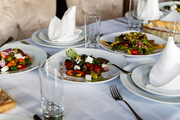 Healthy food. Greek salad with cucumber, tomato, sweet pepper, lettuce, red onion, feta cheese and olives.