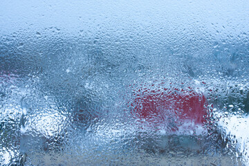Background water drops on the glass, wet window glass with splashes and drops of water and lime, texture autumn background. Condensation on the glass