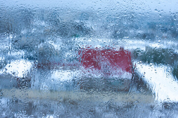 Condensation on the clear glass window. Water drops. Rain. Abstract background texture. Outside the window, bad weather, rain