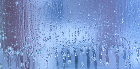 Blue background of natural water condensation, window glass with high air strong humidity, large...