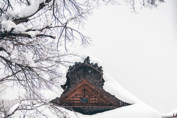 A traditional Japanese architecture during a snowy day.